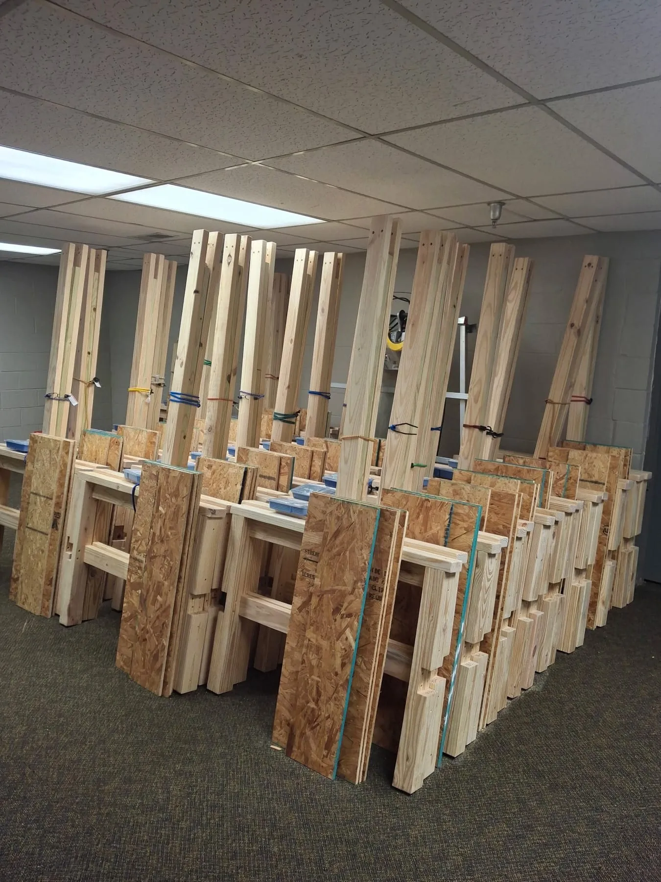 Rows of completed wooden bed components ready for delivery