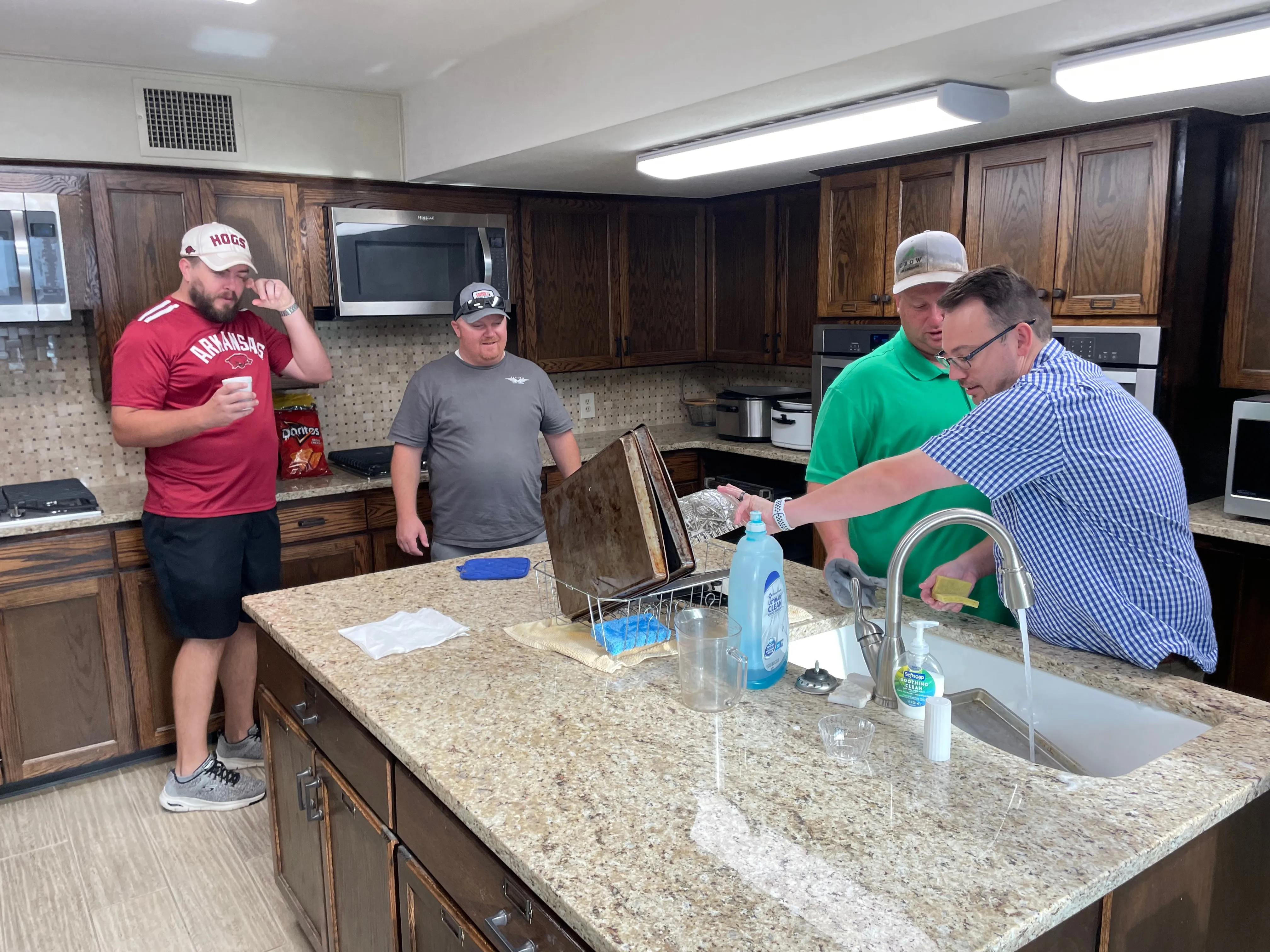 Men working together in the kitchen during breakfast